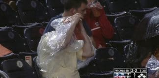 Watch a fan struggle with a poncho at a baseball game