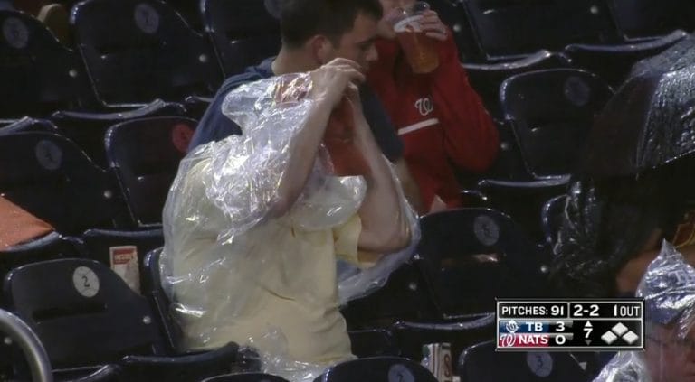 Watch a fan struggle with a poncho at a baseball game