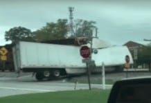 Watch a train plow through a semi truck stuck on the tracks